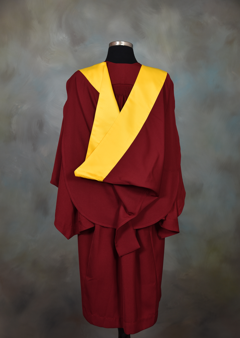 A man in a graduation gown standing in the grass photo – Free Citam karen  (christ is the answer ministries - karen) Image on Unsplash